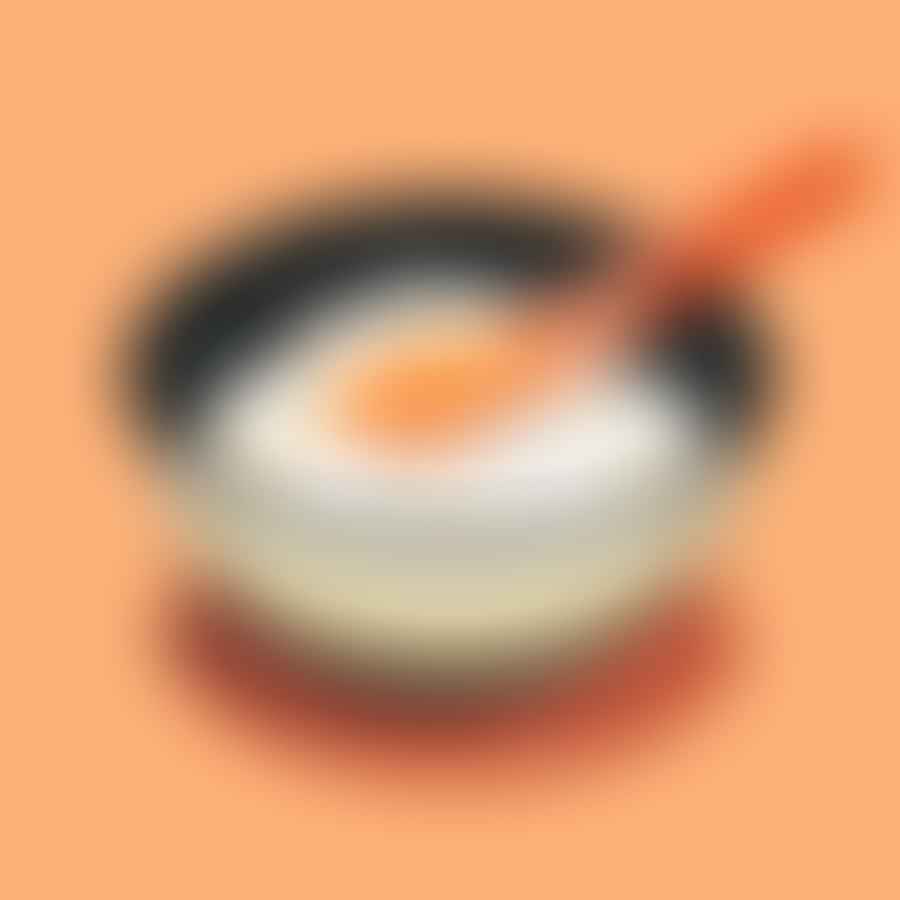 A bowl of freshly cooked sushi rice being mixed with sushi vinegar.