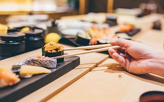 What is the proper way to consume ginger with sushi?
